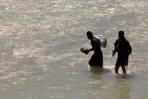 IRAN, 2026 Crossing the rough, swollen river with difficulty during spring migration of the Bakhtiri tribes.