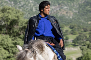 IRAN, 2026 Omid with his fashionable clothes prepares to socialize and meet other nomads and tribes around the camp area.