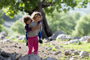 IRAN 2026, Every person in the nomadic life has a role. The six years old Saba takes care of her little brother while her mother is busy with other chores.